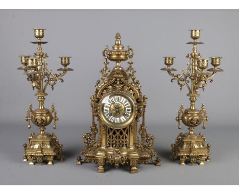 A 19th century French brass mantle clock with two candelabra garnitures signed 'Linderoth a Stockholm' to front, mechanism st