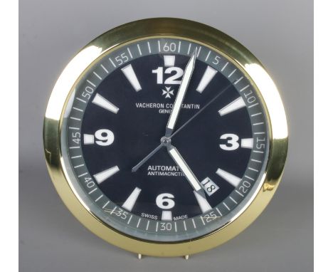 A Vacheron Constantin style wall clock, gold bezel with black dial with Arabic Numeral markers, quartz movement, diameter 40c