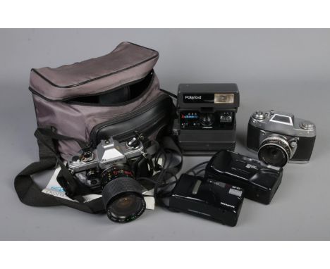 A quantity of vintage cameras including a Yashica FX-D in travel case, Ihagee Dresden Exa-IIa, Polaroid Closeup 636, Olympus 