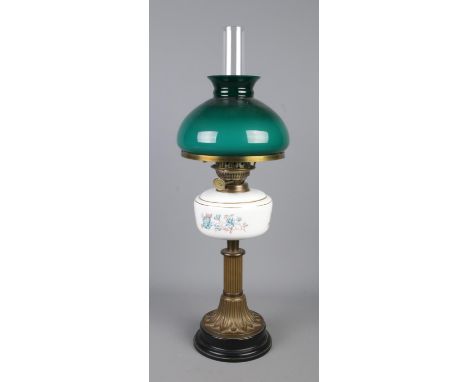 A Duplex oil lamp, with floral decorated reservoir and teal coloured shade.