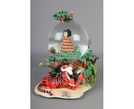 A Disney The Jungle Book snow globe in original box.Hx21cm