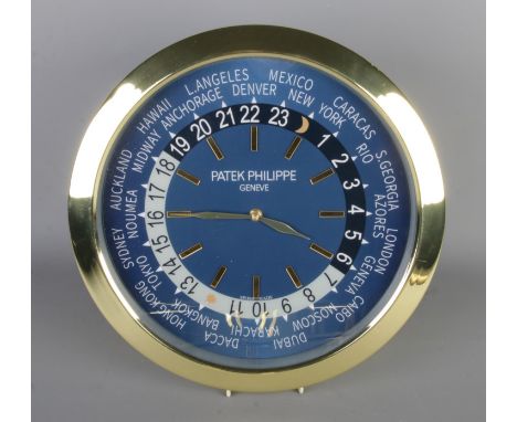A Patek Philippe watch style wall clock, featuring a gold bezel and blue dial, quartz movement, diameter 40cm.