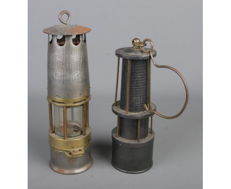 A vintage unmarked miners safety lamp along with a model lamp marked the opening of the Kopalnia Brzeszcze, Poland in 1903.