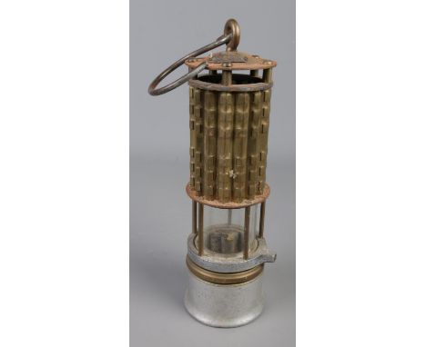 A Wolf Safety Lamp Co. of America miners safety lamp with pierced metal bonnet, Pyrex glass and swing handle. Makers plaque t