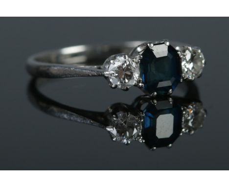 A platinum sapphire and diamond three stone ring. Size J½. Total weight: 2.3g.