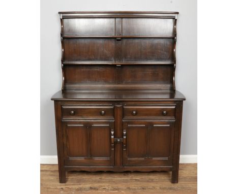 An Ercol Old Colonial dresser featuring two drawers over two cupboards. Height: 161cm, Width: 123cm, Depth: 47cm.