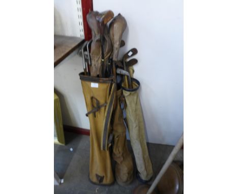 Three vintage golf bags with assorted golf clubs, including hickory shafted
