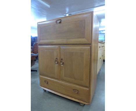 An Ercol Blonde elm 469 model writing desk/cabinet 