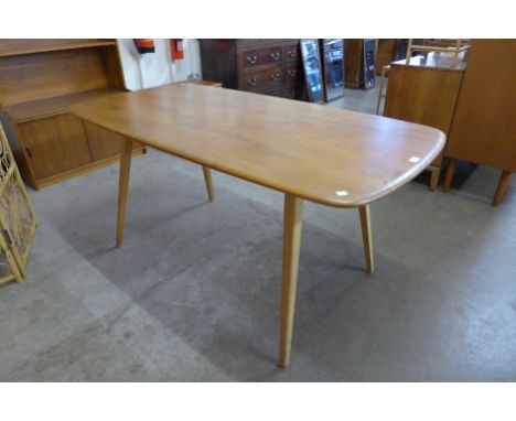 An Ercol Blonde elm and beech plank top dining table 