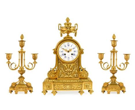 A French Ormolu Striking Mantel Clock with Garniture, circa 1880, surmounted by an urn swag finial, case elaborately decorate