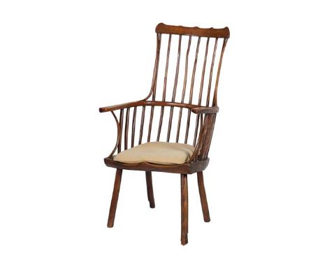 An 18th Century Primitive Oak Stick-Back Armchair, with comb shaped top rail above double spindle supports, moulded seat, wit