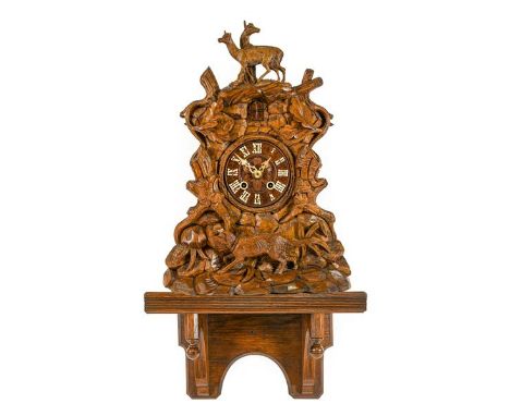 A Black Forest Cuckoo Bracket Clock, circa 1890, elaborately carved case front depicting stags, hunting dog and leaf foliage 