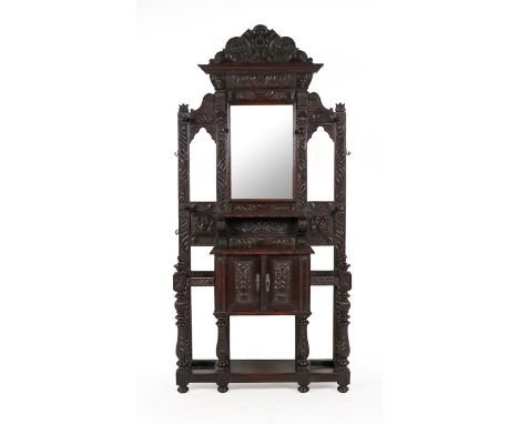 A Victorian Oak Hallstand, 3rd quarter 19th century, carved overall with acanthus leaves and scrolls, the moulded pediment ab