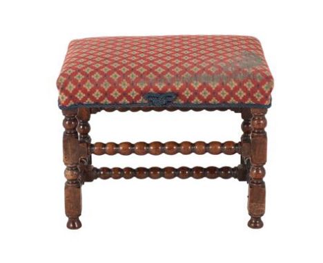 A Turned and Joined Walnut Footstool, 18th century and adapted, later recovered in modern geometric fabric, on bobbin turned 