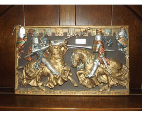 Ceramic wall plaque depicting two knights jousting 