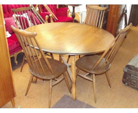 Ercol drop leaf dining table in elm, cross stretcher and splayed legs, with four comb back Ercol dining chairs