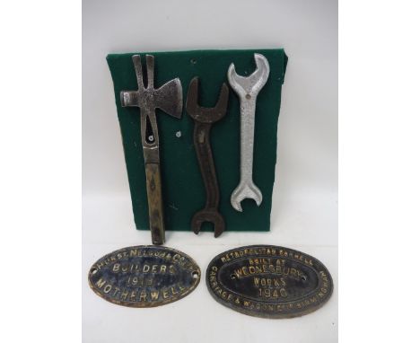 A BR stamped double ended spanner, two further tools and two oval cast iron name plaques, one for Metropolitan Cammell Carria