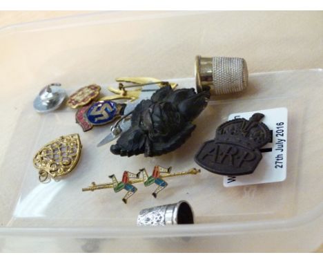 Box of enamel badges and a silver thimble