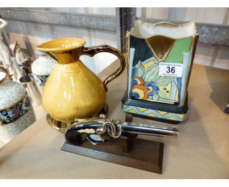 Novelty table lighter in the form of a pistol, an art deco vase and a wade jug