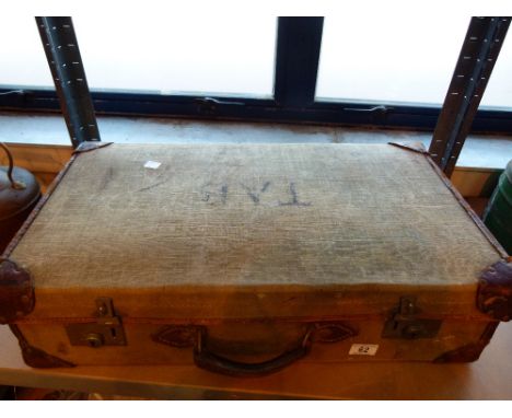 Vintage suitcase with mixed contents including tools