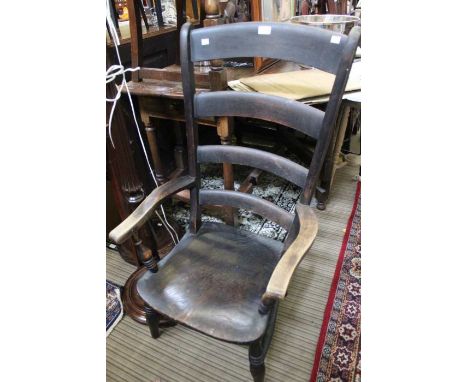 A low 19th century ladder back oak armchair