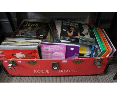 A red travelling trunk containing a large selection of LP's