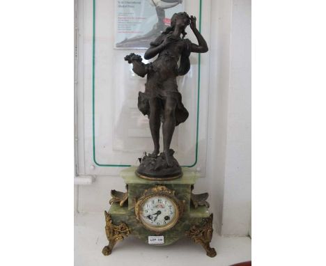 First quarter 20th century probably French onyx clock with cast gilt metal mounts the whole supporting a cast spelter female 