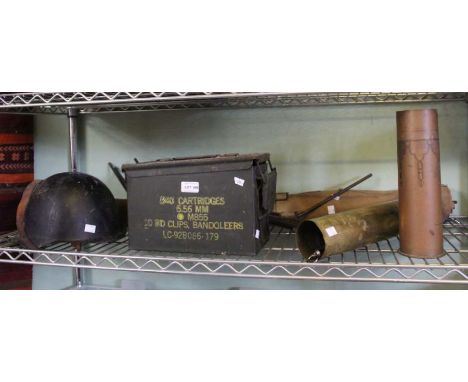 A collection of militaria includes shell cases, camp bed, helmet, ammunition box etc