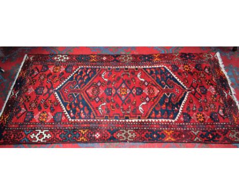 An Iranian hand made carpet/rug, stylised birds and geometric motifs on a scarlet ground, 198cm x 98cm