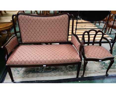 An Edwardian mahogany framed sofa, shaped rectangular back, serpentine arms terminating in an unornamented scroll, stuffed ov