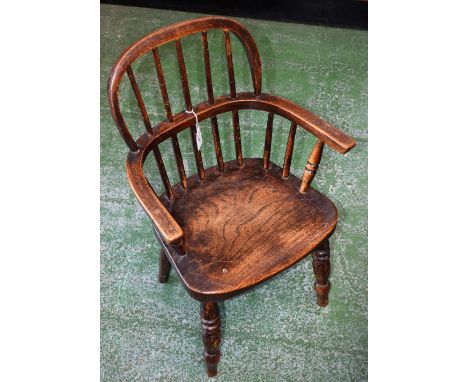 A Country house elm seated child's Windsor elbow chair, ring turned forelegs, 61cm high