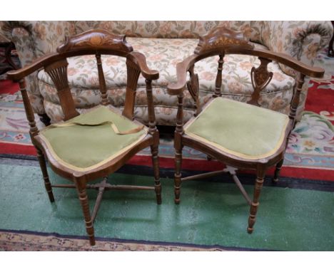 An Edwardian mahogany corner chair, curved cresting rail inlaid with scrolling foliage, turned supports, vasular splats, ring