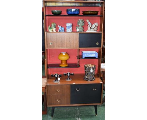 A retro mid-20th century design G Plan side cabinet, the shaped superstructure with an open shelf above a pair of sliding doo