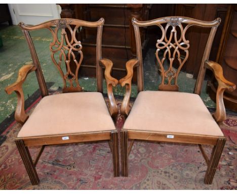 A pair of Chippendale Revival open armchairs, each with a cupid's bow cresting rail applied with ribbon-tied foliage, pretzel