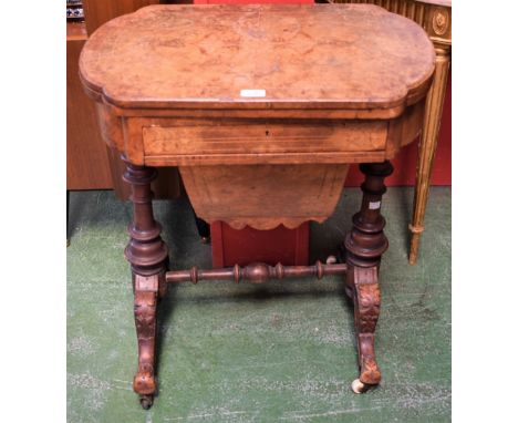 A Victorian walnut games/work table, hinged shaped rectangular top enclosing surfaces for chess and backgammon above a single