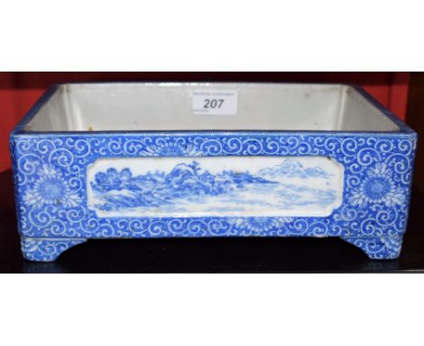 A large Chinese blue and white bonsai trough, the sides with panels inset, painted with pagoda and mountainous landscape scen