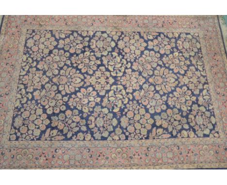 A Persian style hand made carpet/rug, woven with sprays of flowers and foliage on a predominantly Aegean blue ground, 295cm x