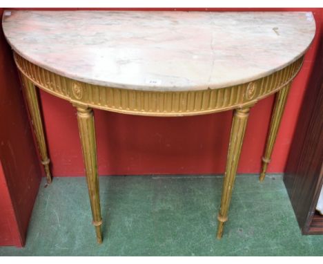 A Louis XVI Revival giltwood demi-lune console table, marble top above a frieze applied with flowerheads in a beaded border, 