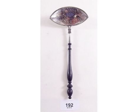 A silver straining ladle with turned wooden handle, Chester 1906 by BM (import hallmarks)