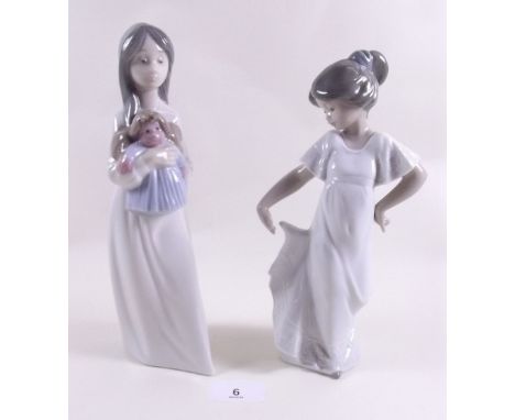 A Lladro Nao figure of a girl carrying a doll and girl with a dress 