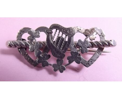 An Edwardian silver shamrock brooch with gold harp inlay