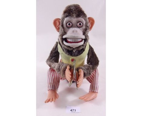 A vintage toy monkey, plush covered body, plastic hands and feet, battery operated - plays cymbals and bares teeth, 30cm high