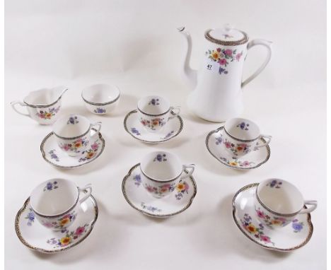 A floral printed coffee service comprising coffee pot, six cups and saucers, jug and sugar 