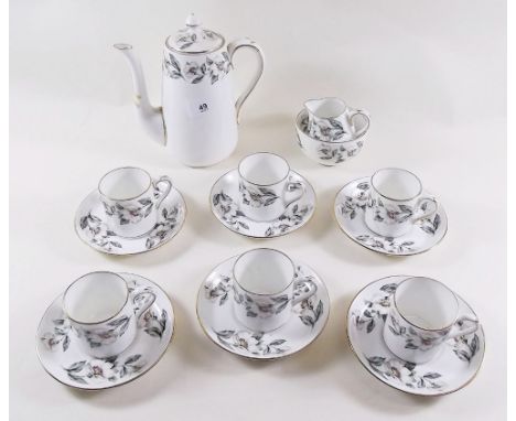 A Crown Staffordshire coffee service comprising coffee pot, sugar, milk, six cups and saucers and six tea plates printed rose