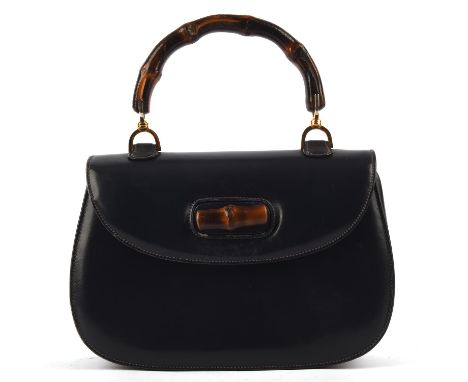 GUCCI A classic 1970s navy blue leather handbag with bamboo handle and twist clasp (27cm x 18cm x 8cm) Photo for illustrative
