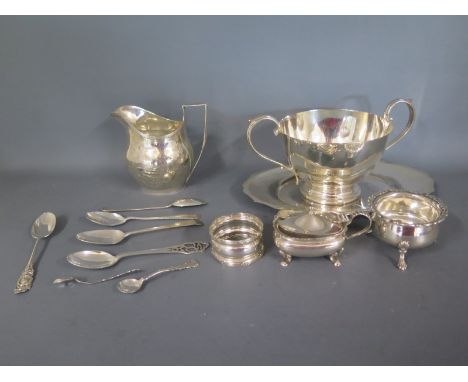 A collection of various silverware to include helmet cream jug cruet items, spoons and napkin ring plus further plated sugar 