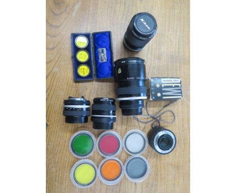 A collection of various camera lenses to include Nikkon/Nikkor plus light filters and further cased lenses marked Singer Shep