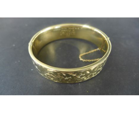 A 9ct yellow gold hallmarked bangle - 7cm x 6.5cm x 1.5cm - approx weight 27.2 grams