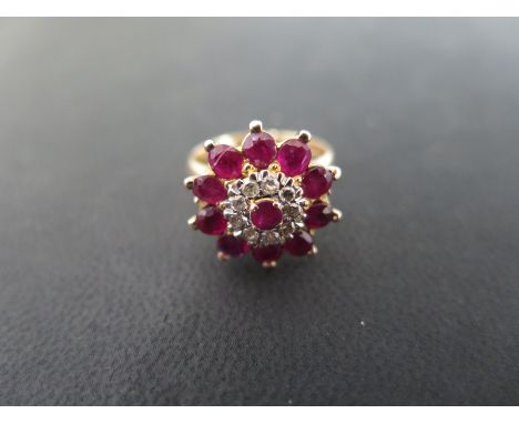 A ruby and diamond yellow gold cluster ring - approx weight 5.4 grams - has been re sized taking hallmarks out, but believed 