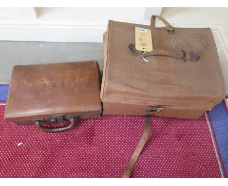 A small canvas bound trunk and a small leather suitcase